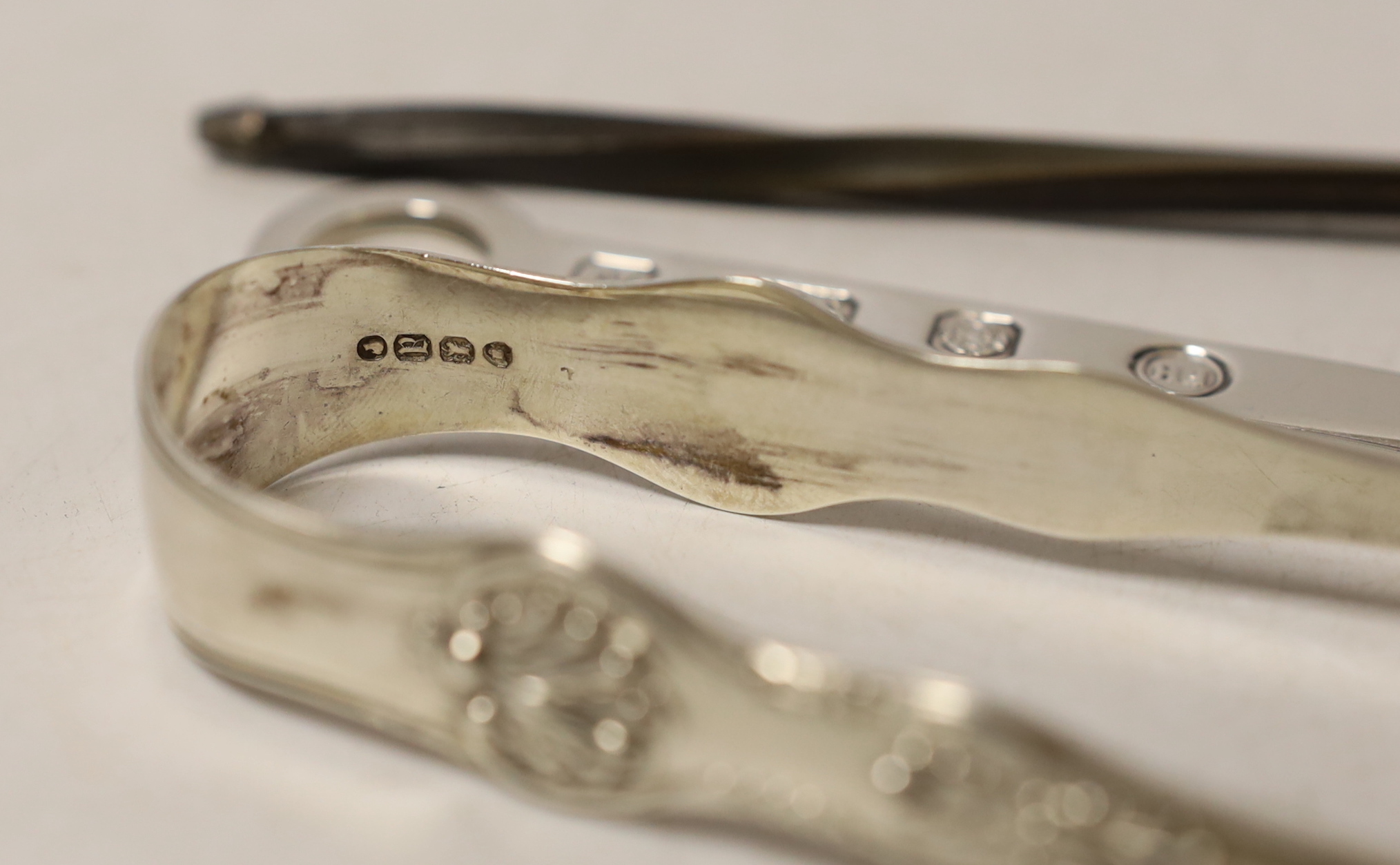 Two pairs of silver sugar tongs, including Victorian King's pattern a white metal toddy ladle and a modern silver letter opener.